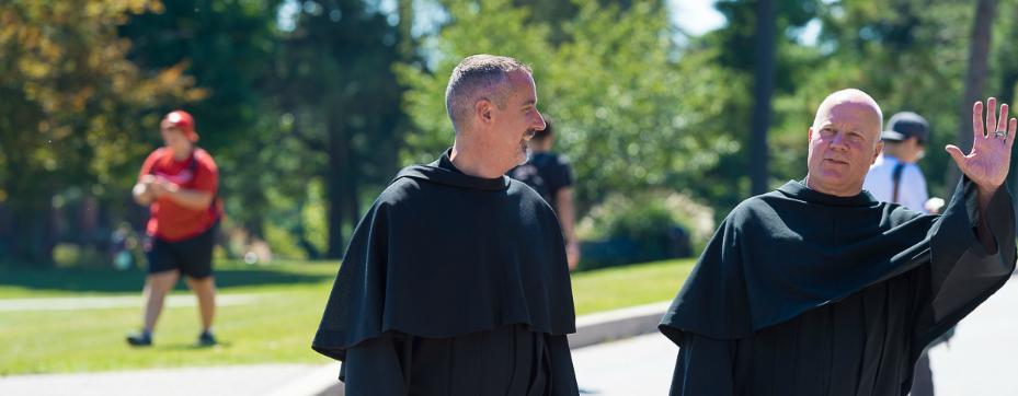 Fr. Lehman and Fr. Malachi walking on campus